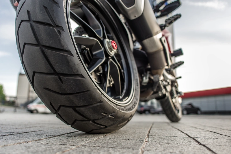 Rear wheel of Red motorcycle in the city street